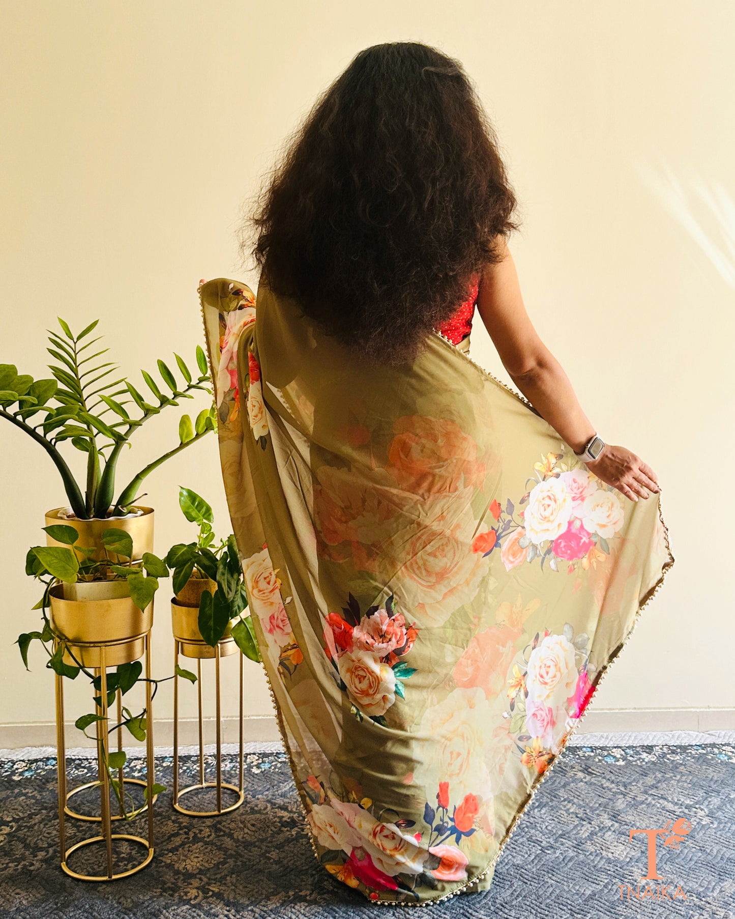 Soft georgette saree with floral prints and elegant pearl lace finish.