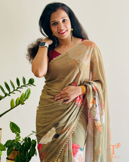 Lightweight floral georgette saree featuring pearl lace detailing for festive wear.