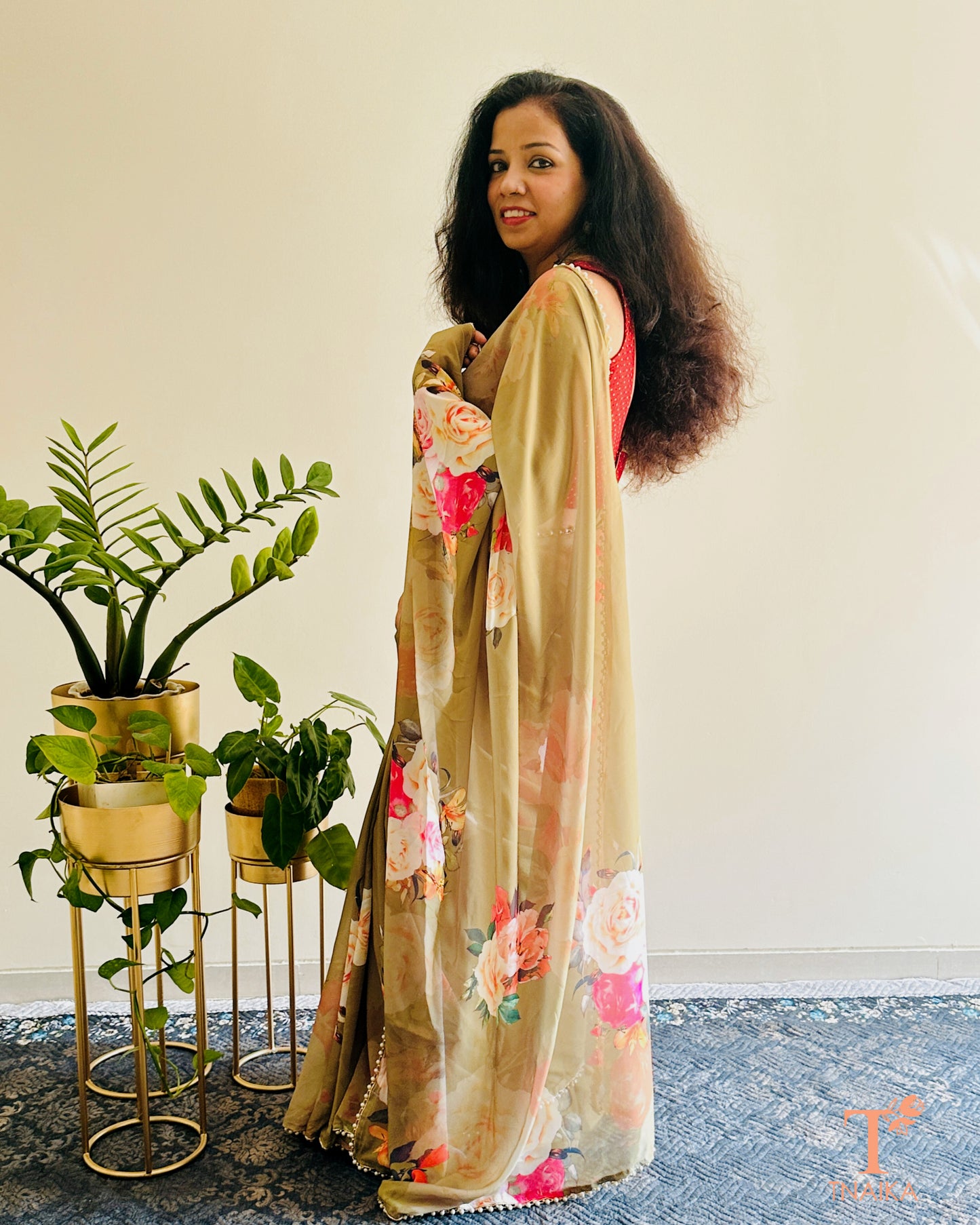 Lightweight floral georgette saree featuring pearl lace detailing for festive wear.