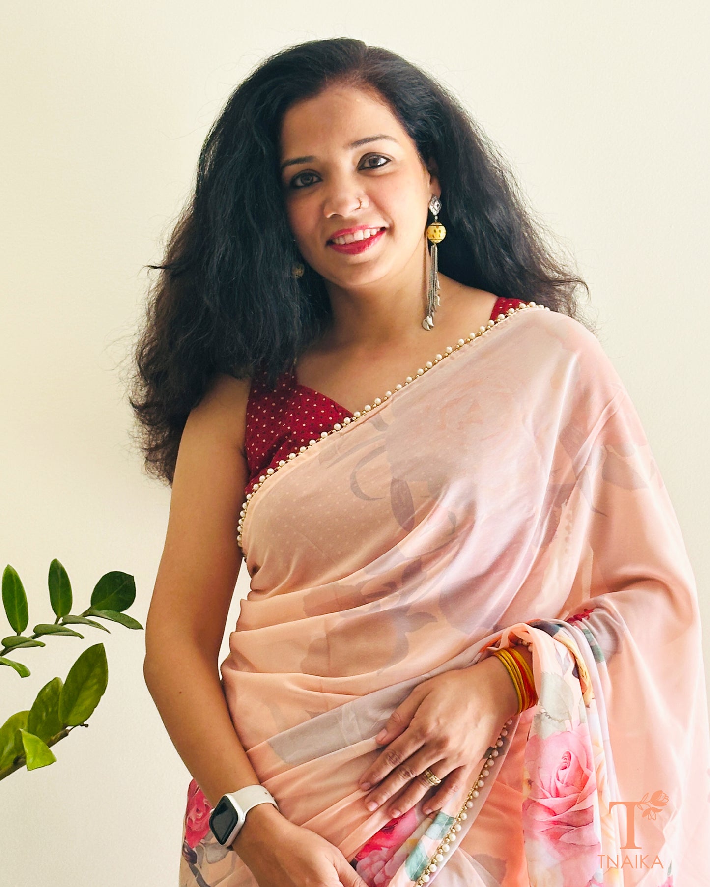 Lightweight flowy georgette saree featuring floral prints and pearl lace detailing