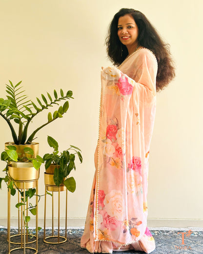 Graceful georgette floral saree with soft drape and pearl lace embellishment