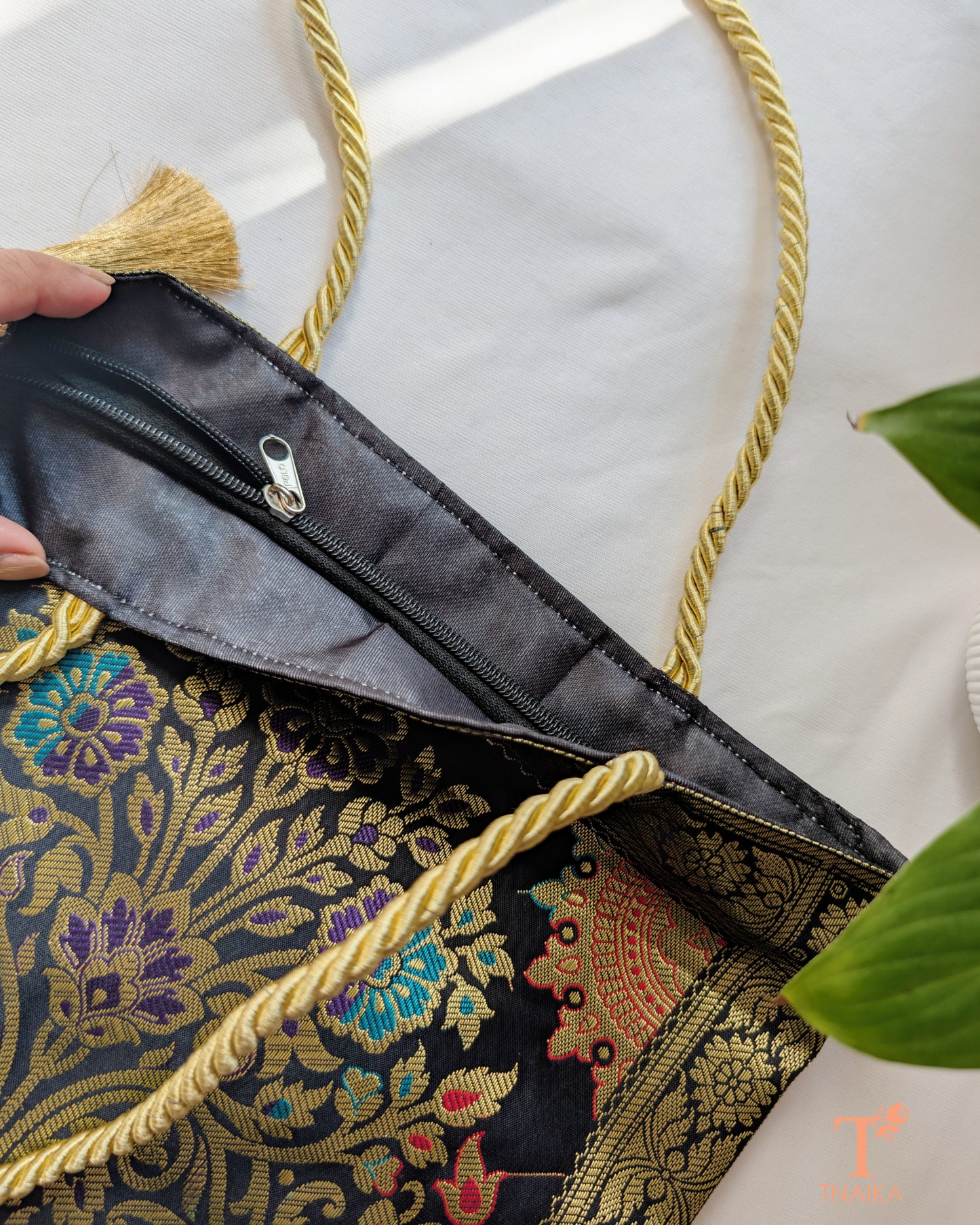 Handcrafted Banarasi bag featuring rich patterns and ethnic detailing