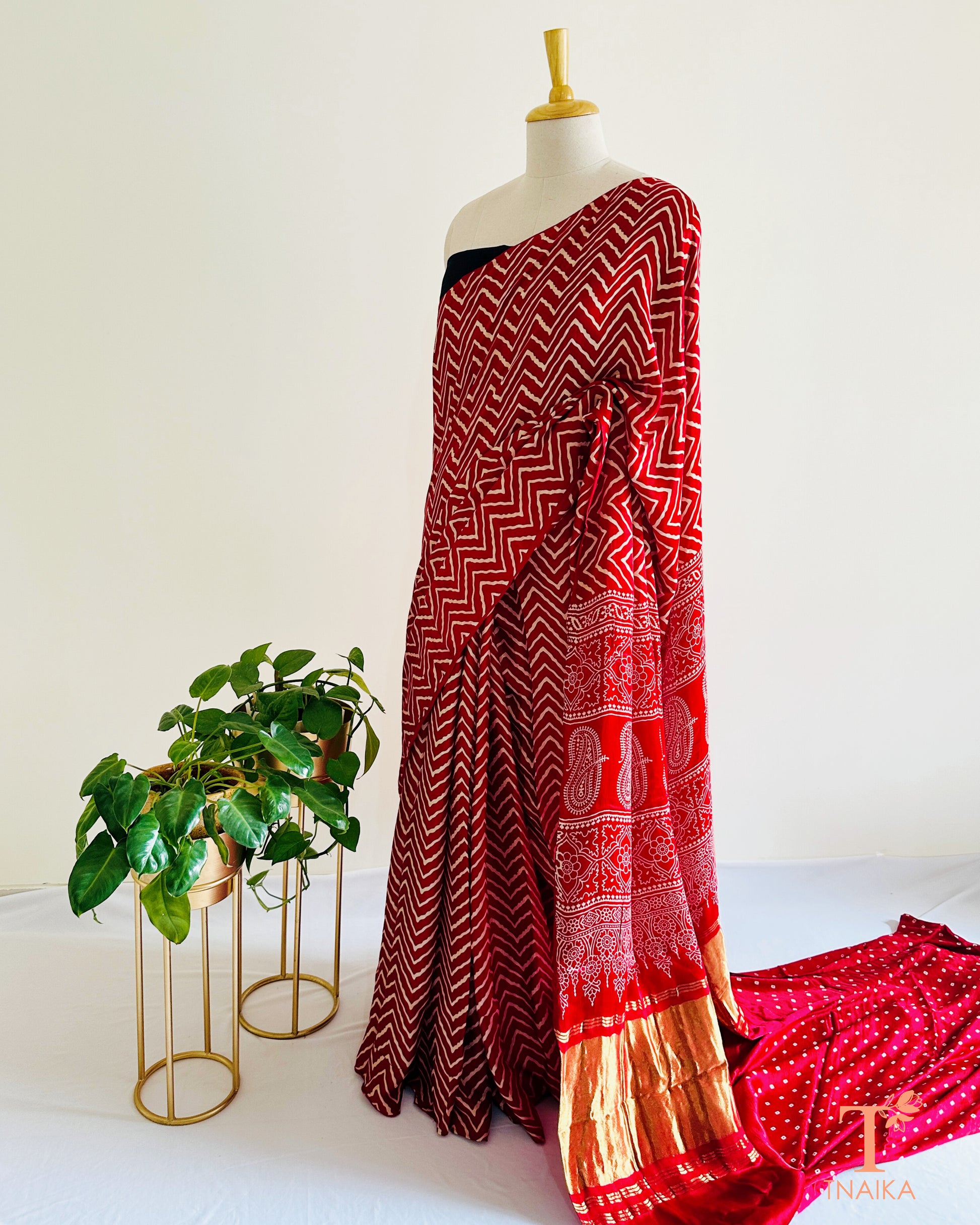 Festive modal silk saree with classic leheriya pattern, tissue lagadi patta-style pallu and Ajrakh accents, includes bandhani running blouse.