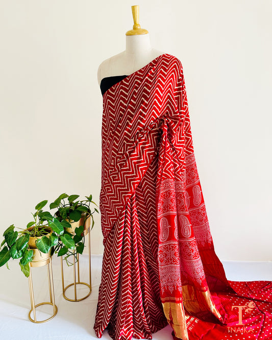 Modal silk leheriya saree with tissue lagadi patta pallu and Ajrakh detailing, paired with unstitched bandhani running blouse.