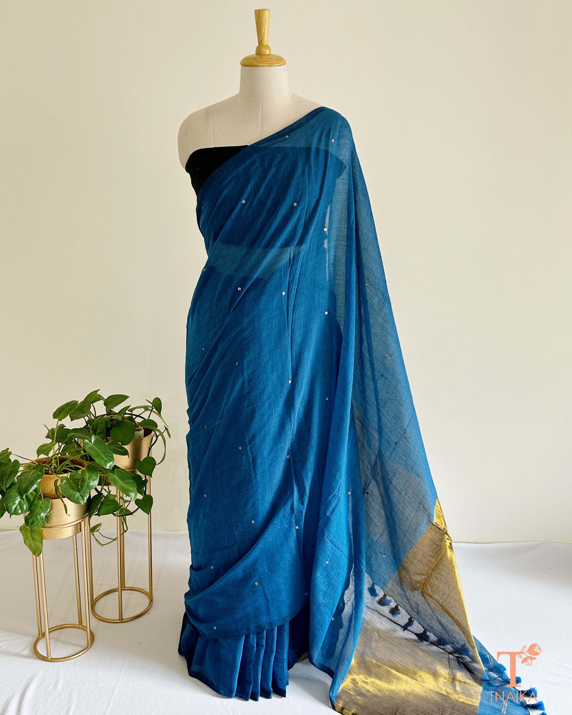 Cotton saree with delicate foil tikki work and golden tissue pallu.