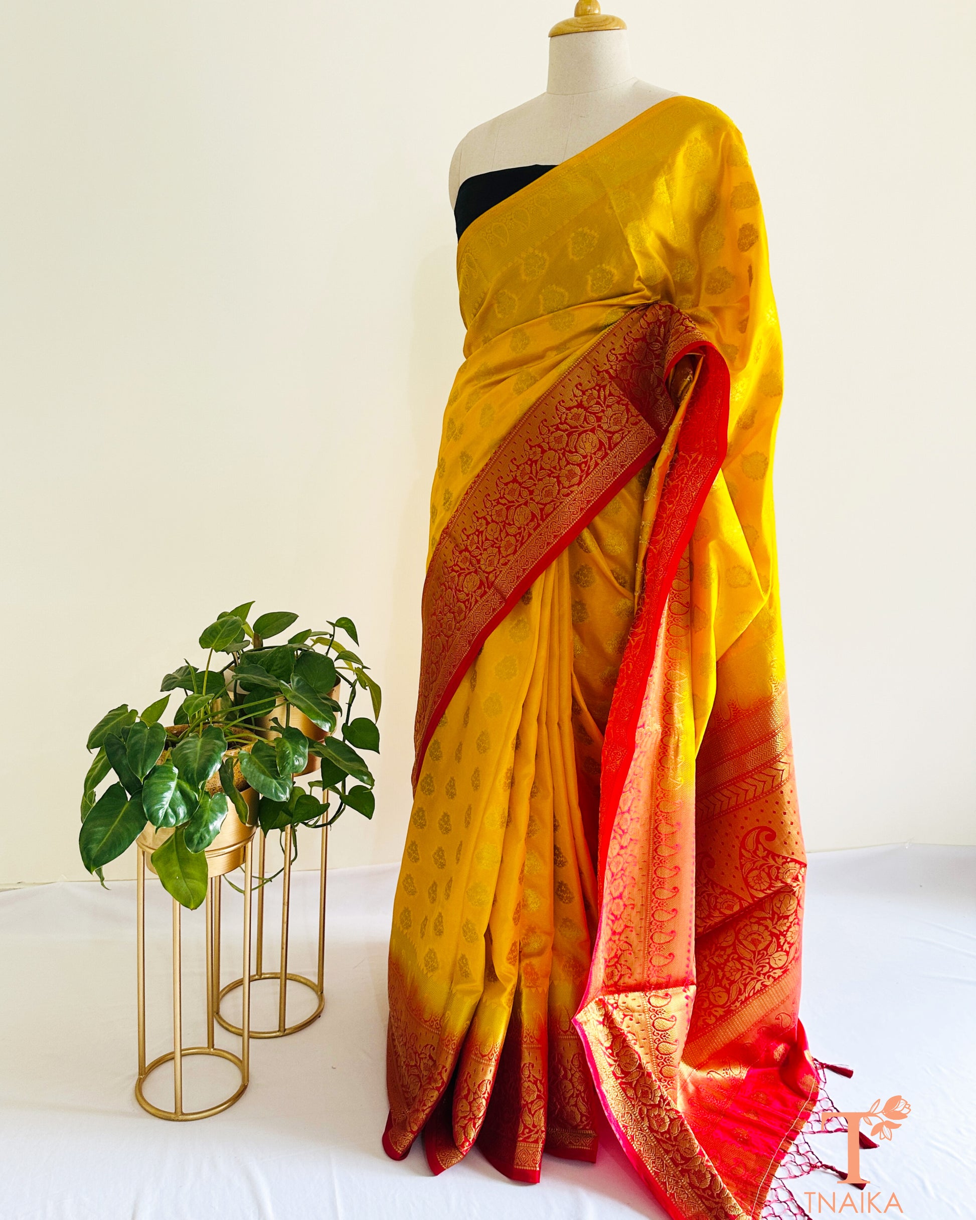 Festive yellow red semi silk saree with traditional Banarasi style detailing and classic finish.