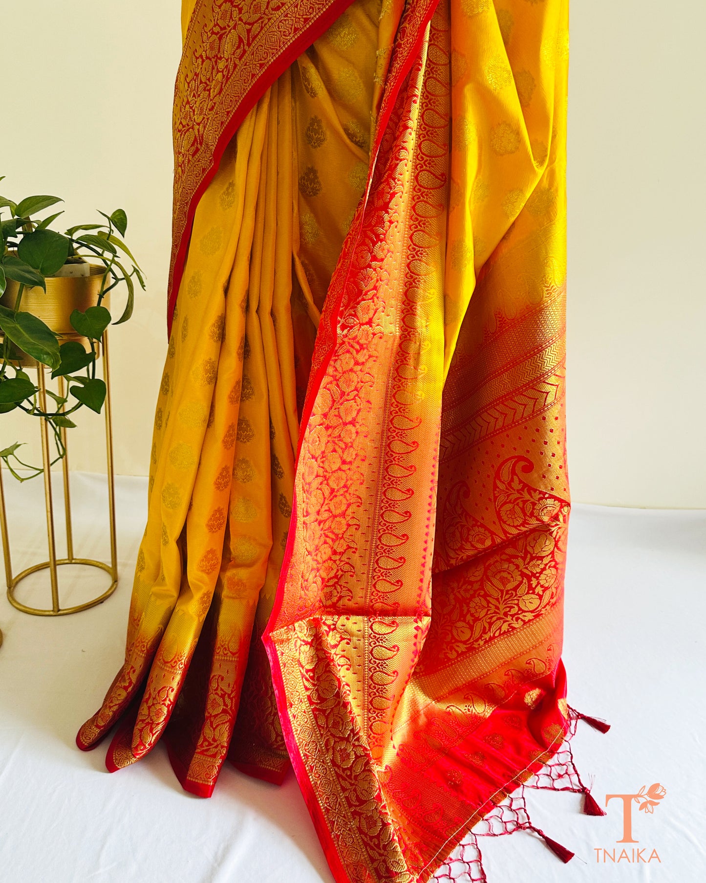 Yellow red semi silk saree with grand Banarasi look, ideal for wedding guest and festive wear.