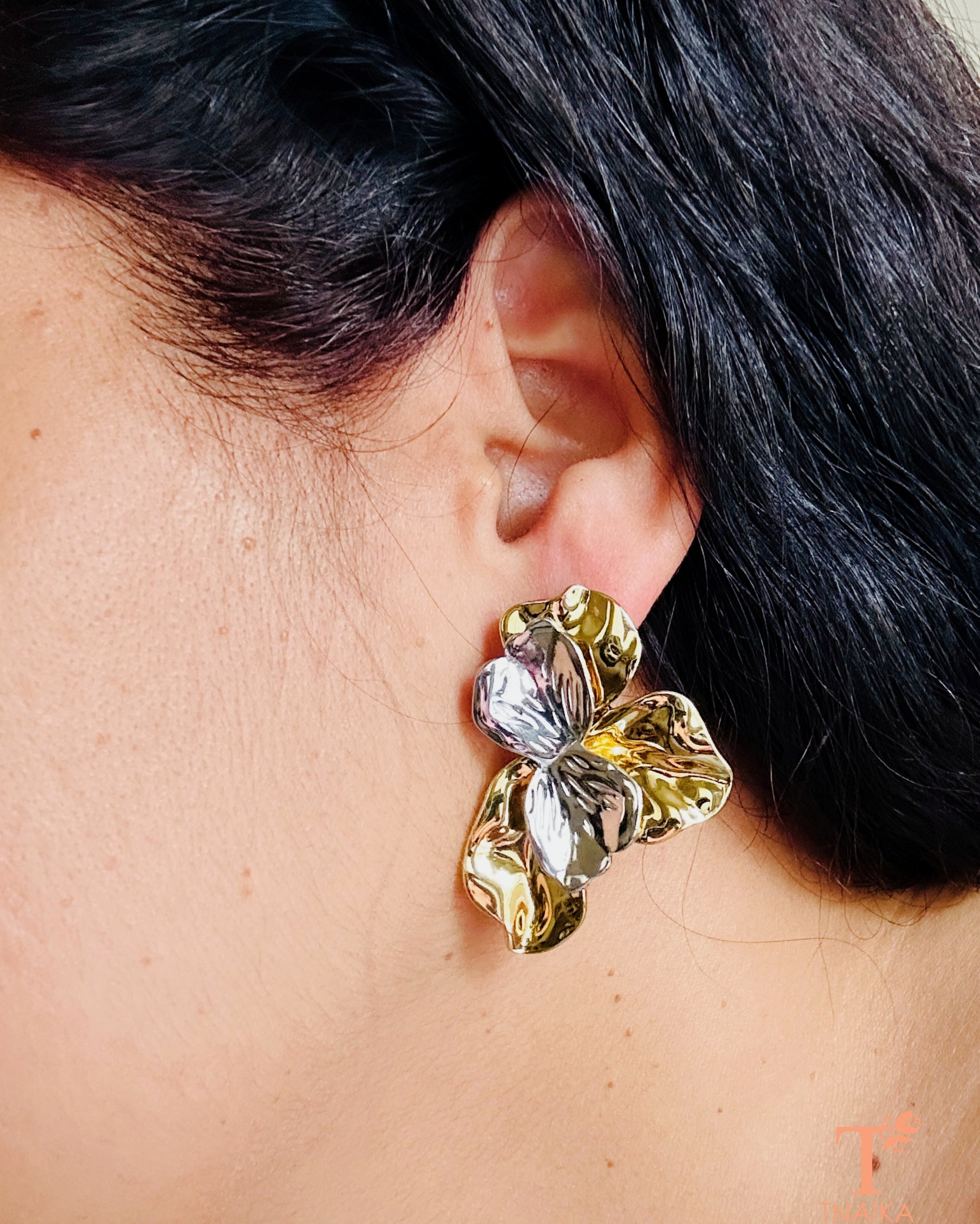 Anti-tarnish dual tone stud earrings featuring modern floral petal shape in metallic shine.