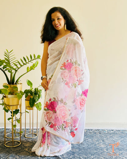 Lightweight floral georgette saree featuring pearl lace detailing for festive wear.