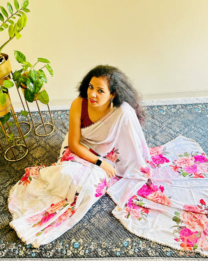 Lightweight floral georgette saree featuring pearl lace detailing for festive wear.