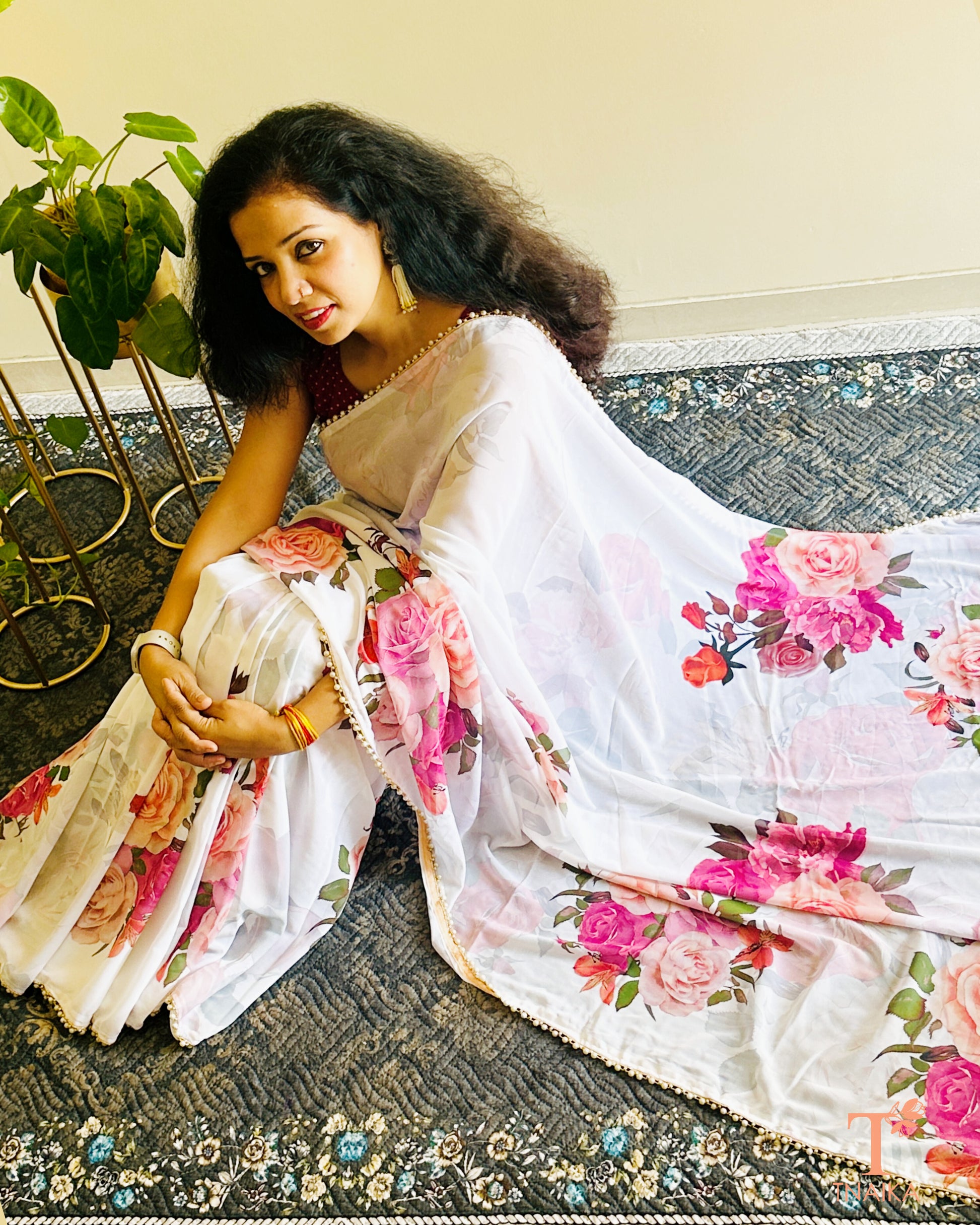 Flowy floral georgette saree paired with a coordinated floral blouse.