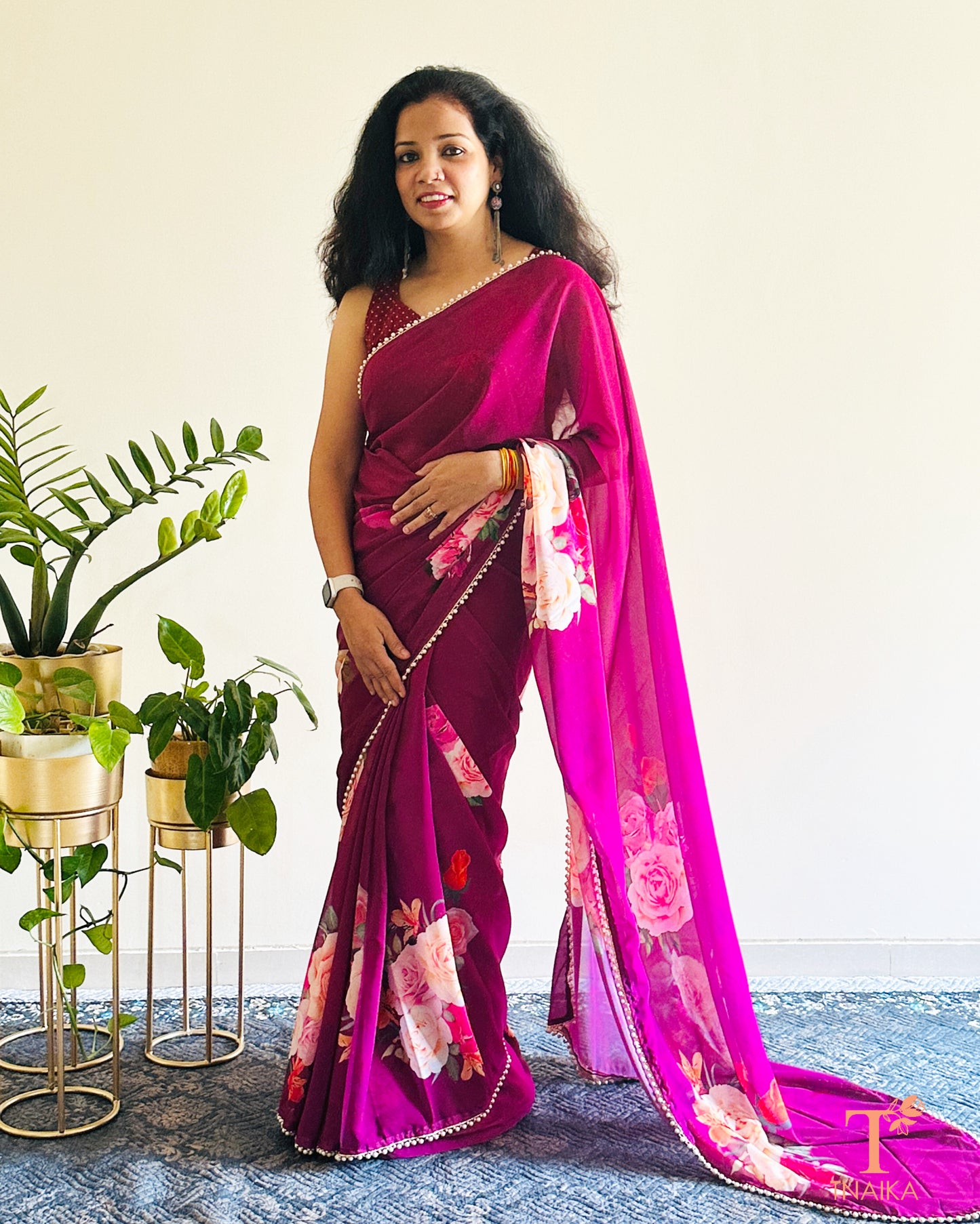 Festive floral georgette saree with pearl lace border, perfect for parties and gatherings.