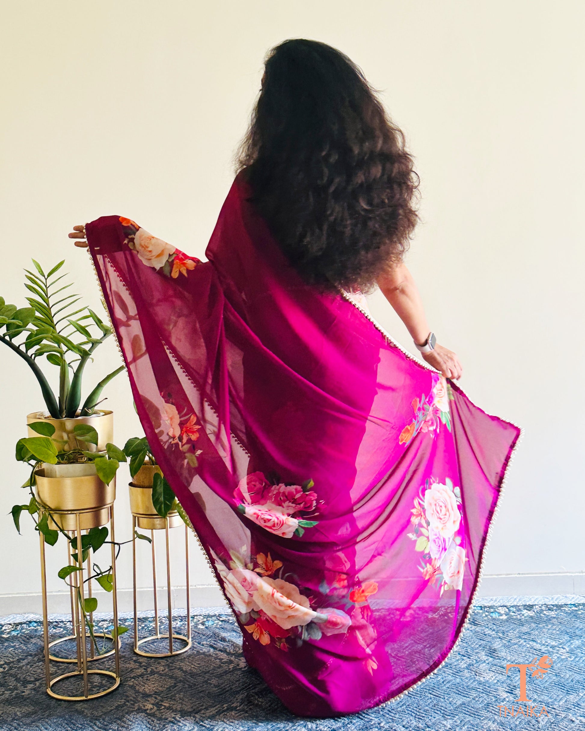 Flowy floral georgette saree paired with a coordinated floral blouse.