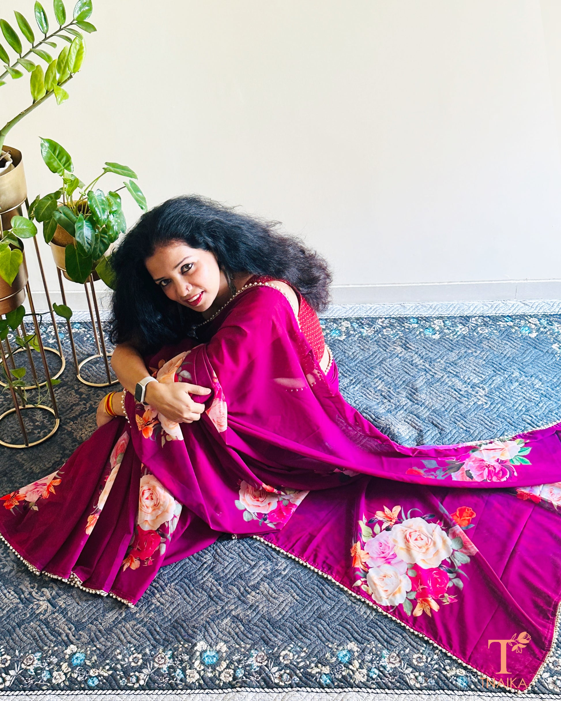 Soft georgette saree with floral prints and elegant pearl lace finish.