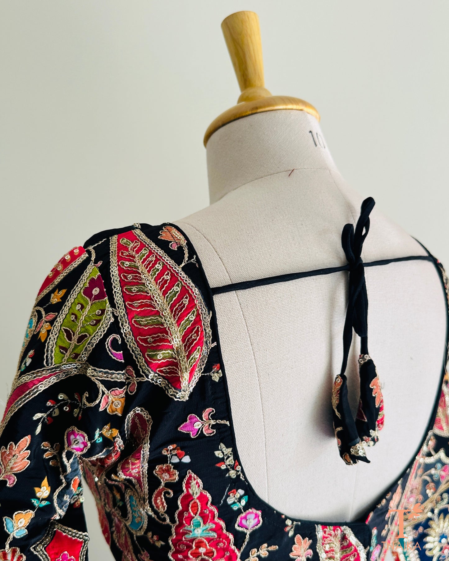 Lightweight embroidered crepe blouse with graceful fall and minimal elegant design for saree styling.