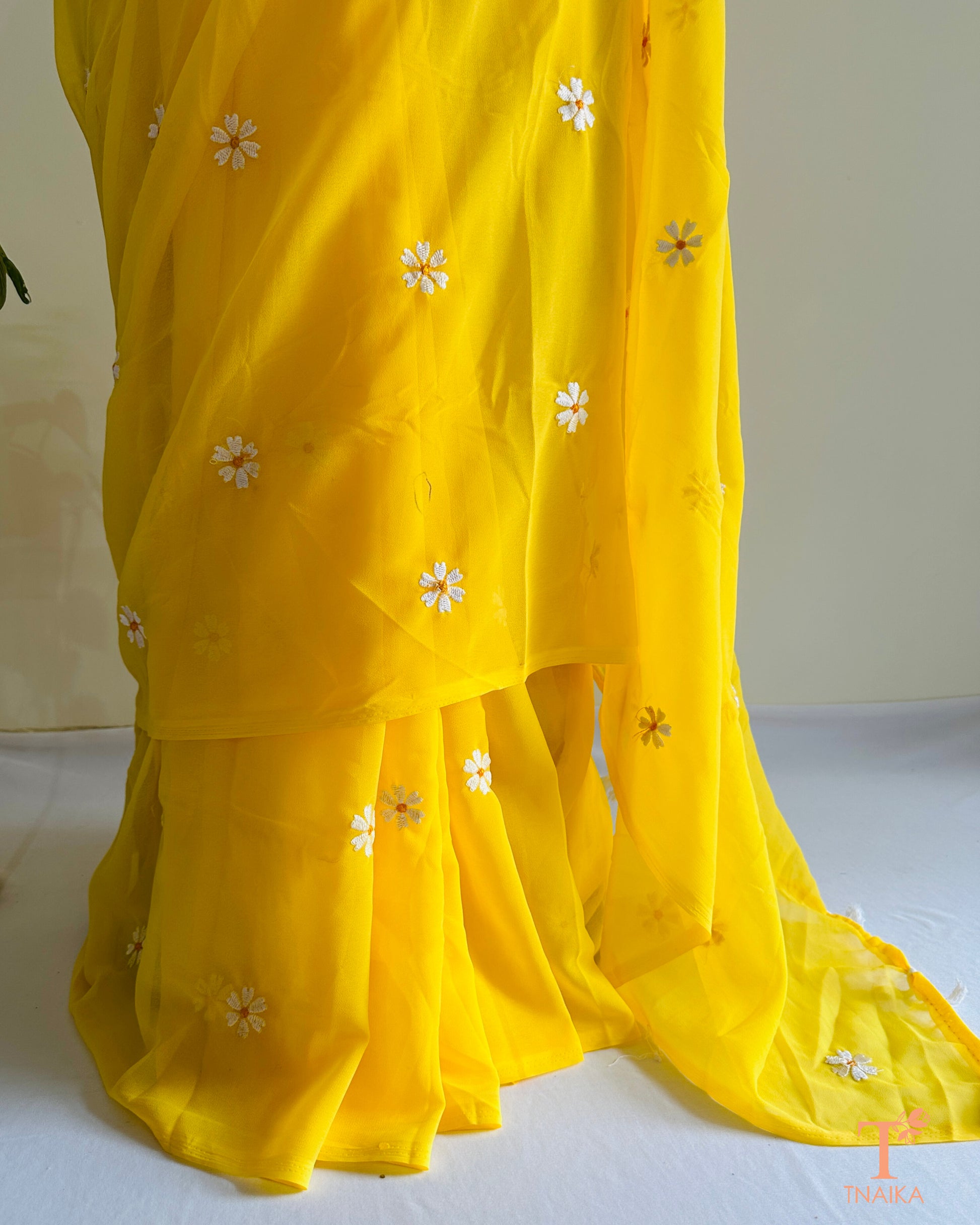 Georgette saree featuring Parijat floral motifs with blouse fabric