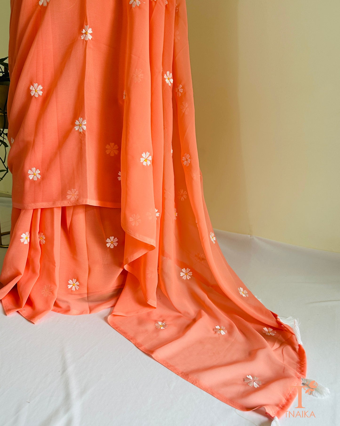 Georgette saree featuring Parijat floral motifs with blouse fabric