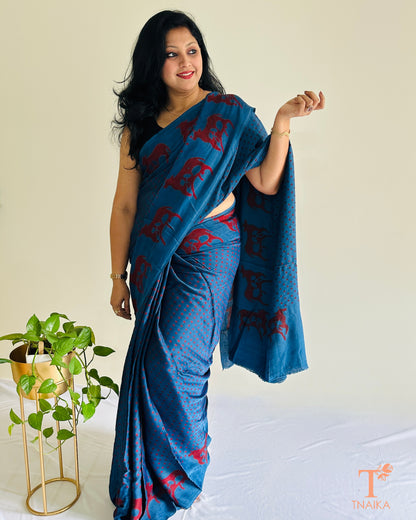 Custom blue modal silk saree featuring Indian cow design on border