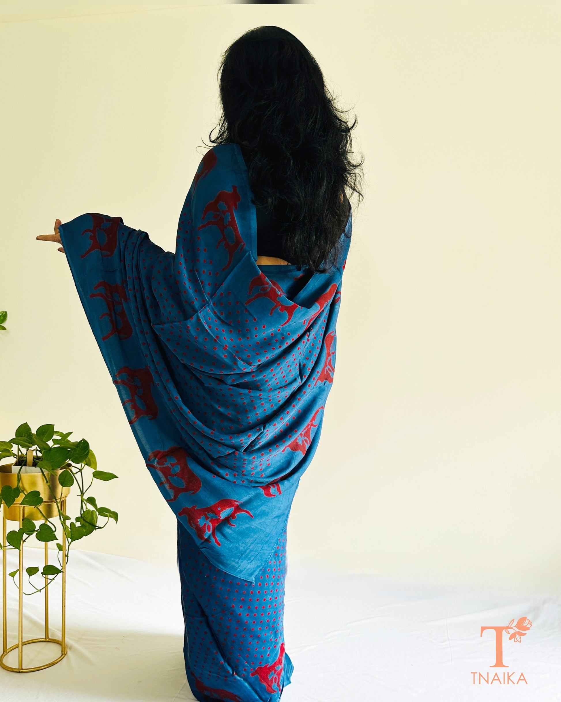 Blue modal silk saree with red polka dots and traditional cow motif border