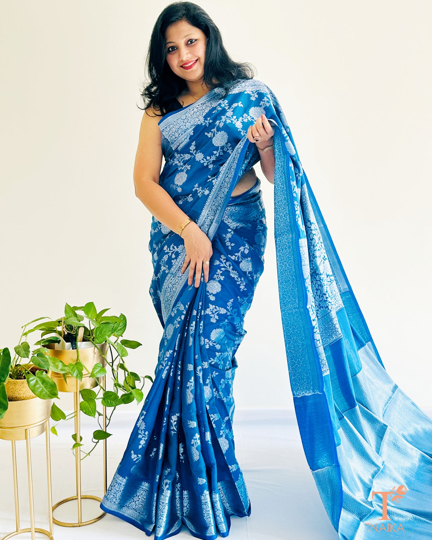 Close-up view of silver zari floral weaving on Banarasi silk saree