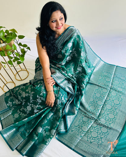Close-up view of silver zari floral weaving on Banarasi silk saree