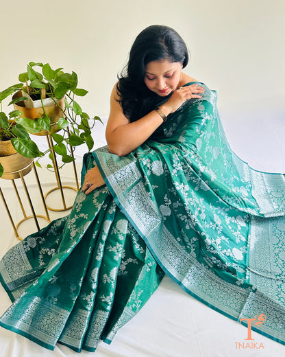 Banarasi silk saree featuring silver zari floral motifs and border
