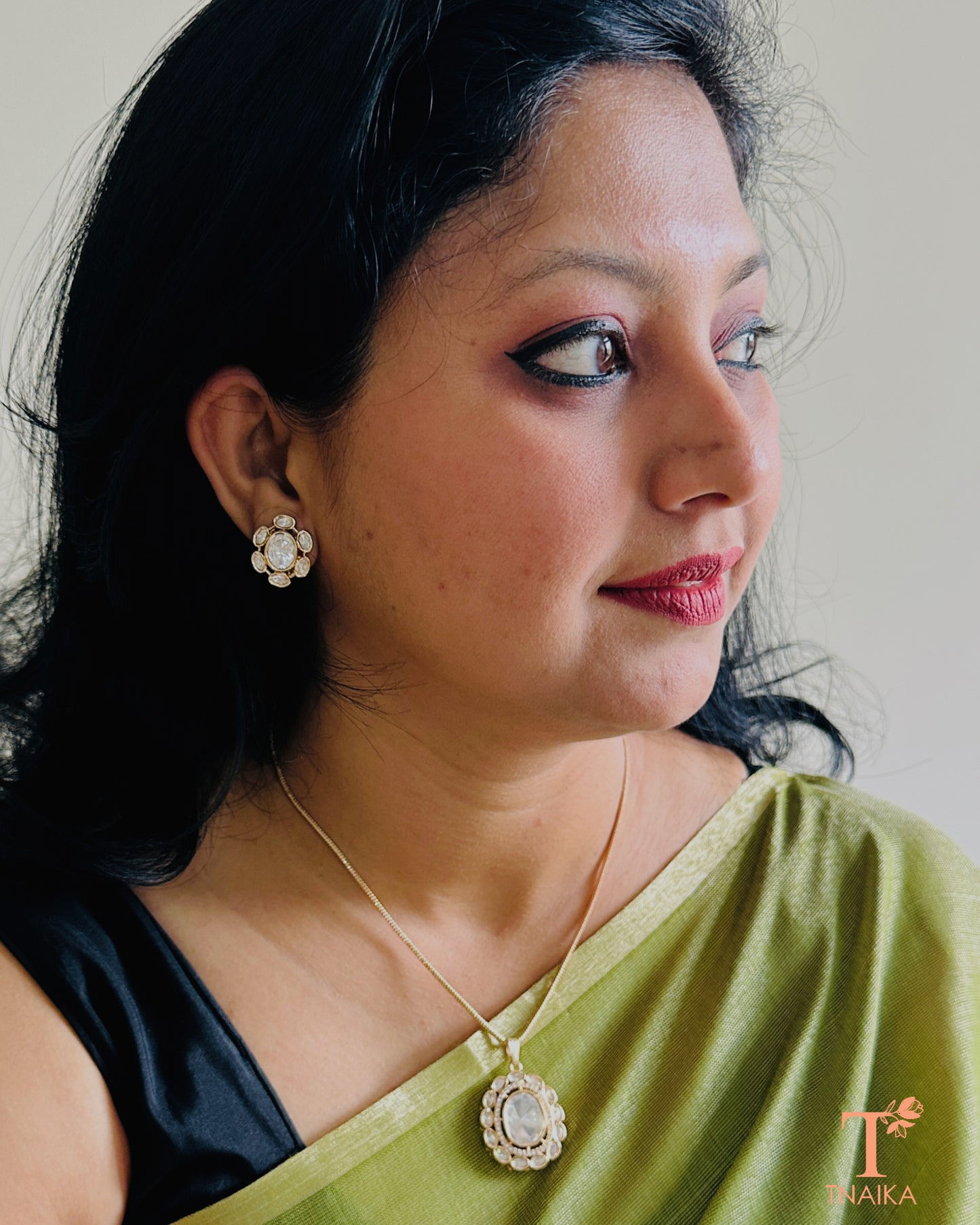 Elegant polki pendant and stud earring set for festive and occasion wear.