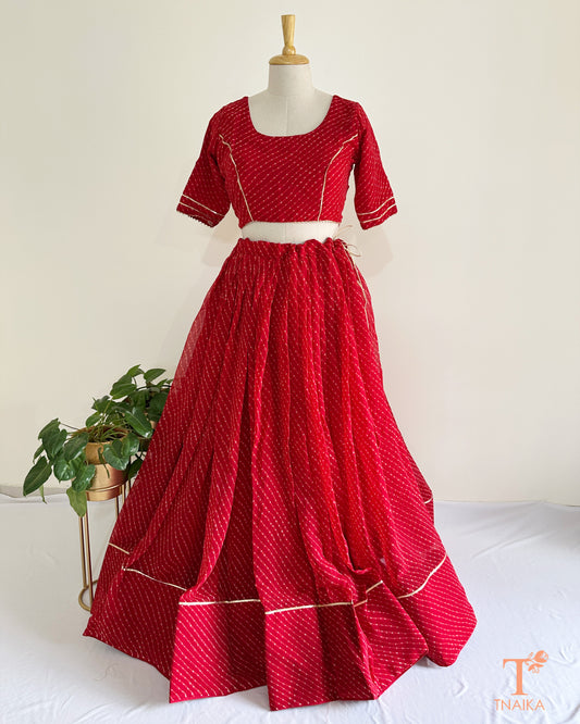 Flowy georgette Leheriya lehenga set with delicate lace work, paired with matching blouse and dupatta