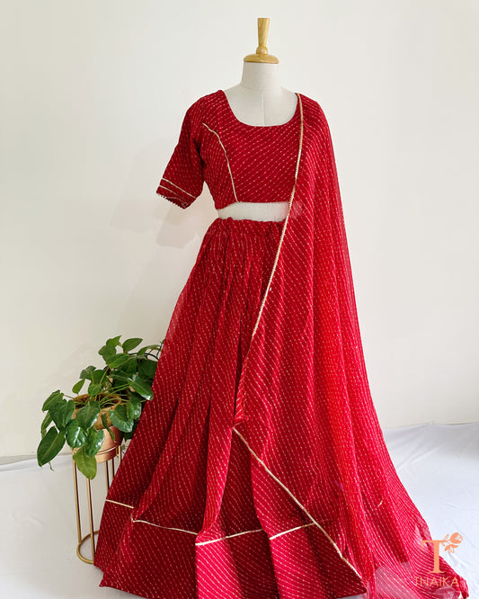 Vibrant Leheriya georgette lehenga featuring lace detailing, ideal for weddings and festive occasions
