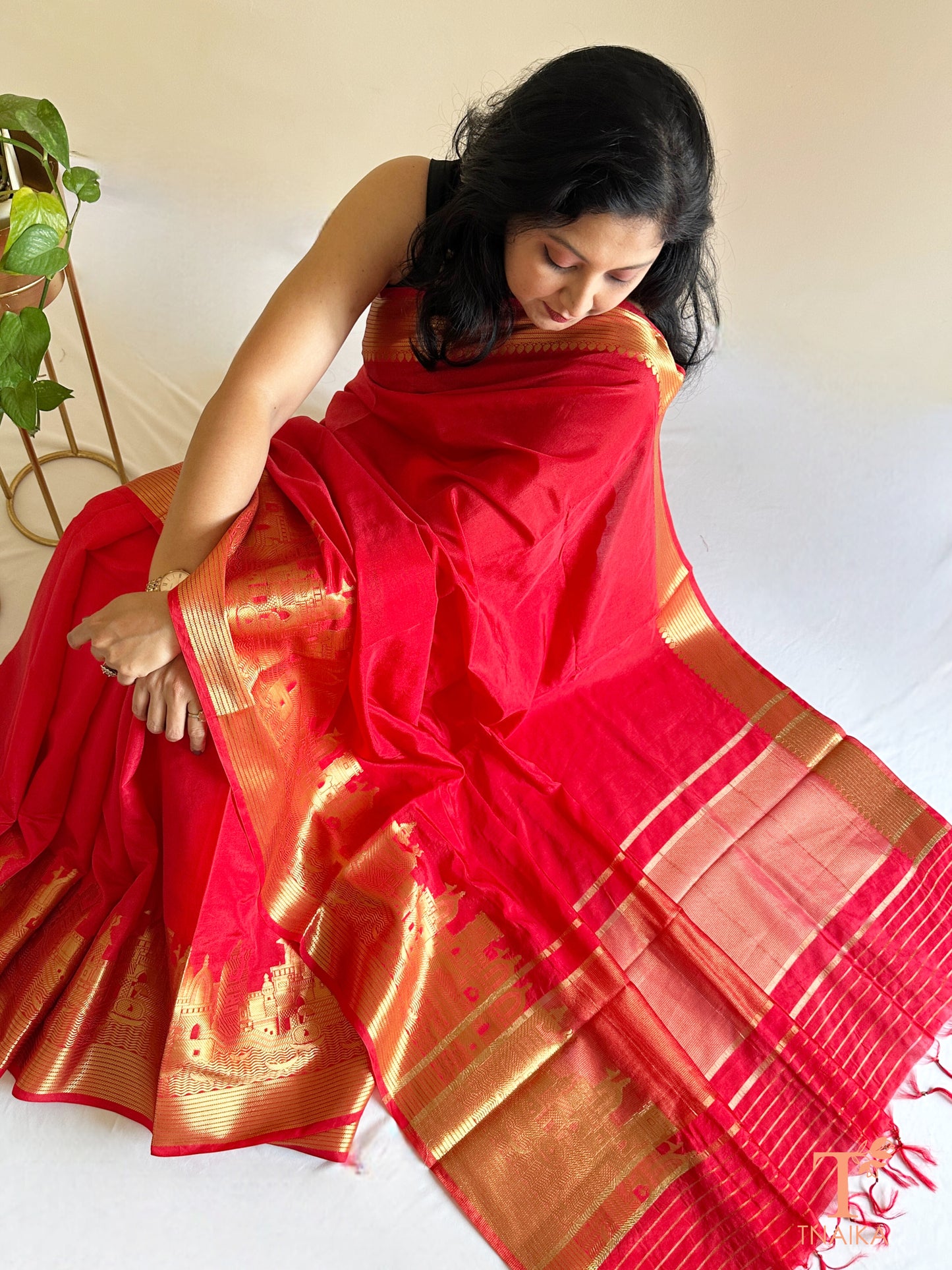 traditional red silk saree with temple inspired border