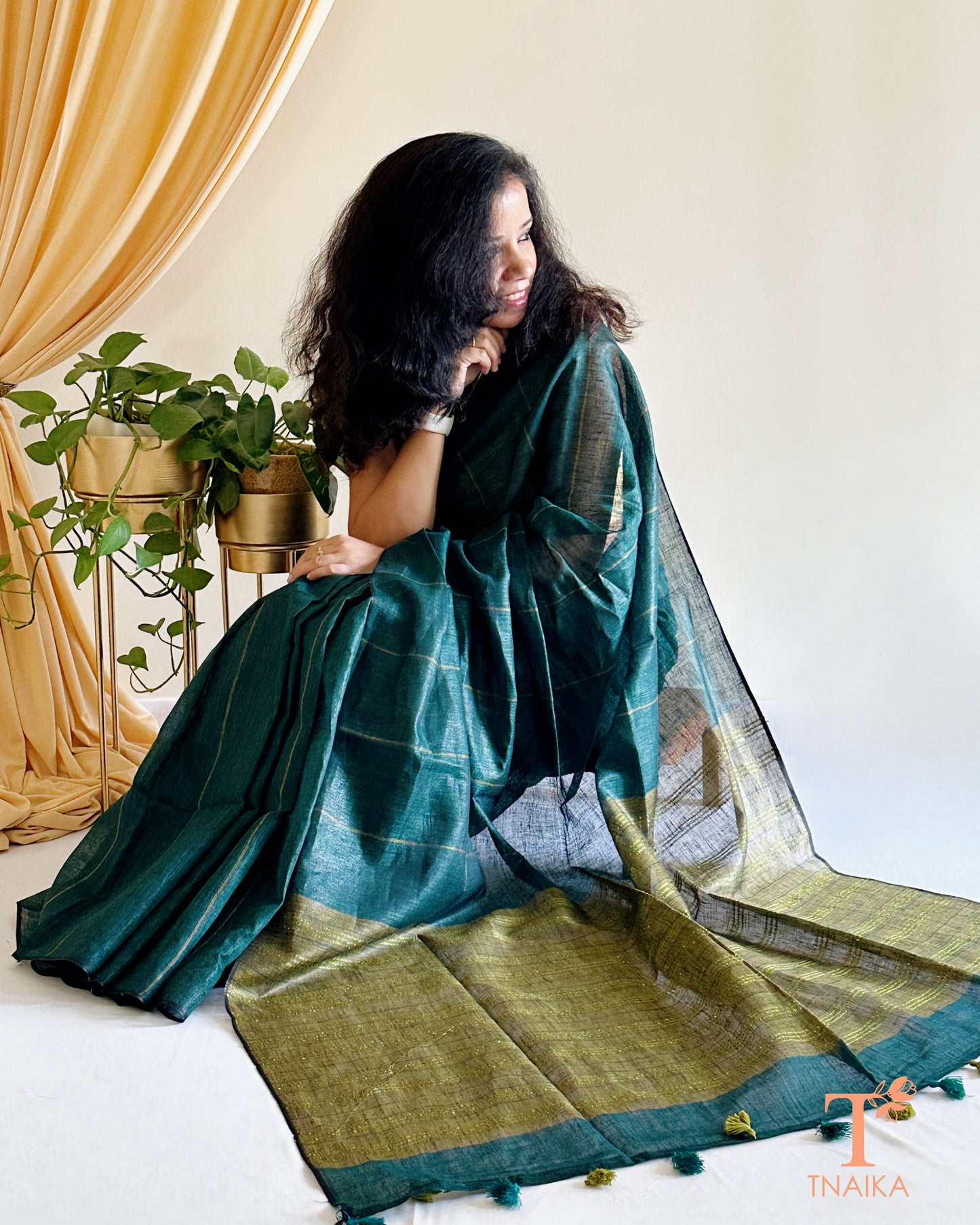 elegant dark green linen cotton saree with tassels