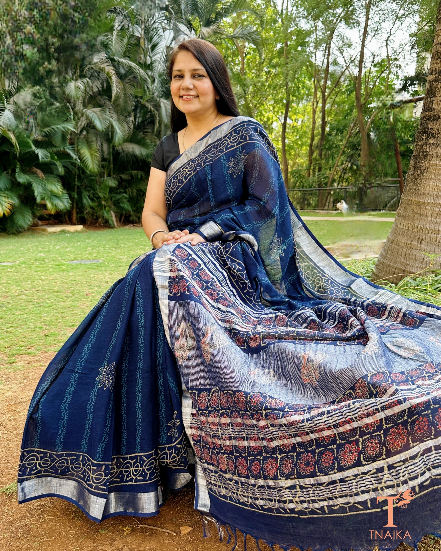 elegant linen saree in deep blue with traditional motifs and tassels