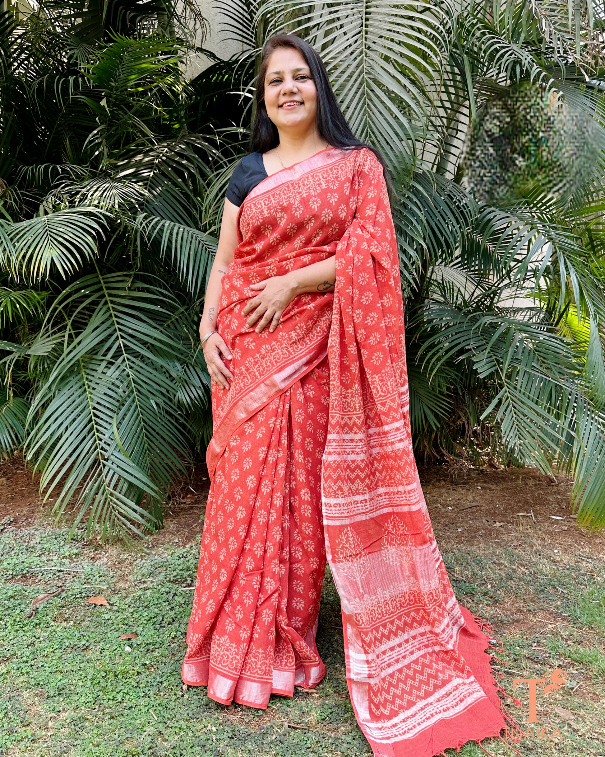 textured linen cotton saree in coral shade with detailed pallu