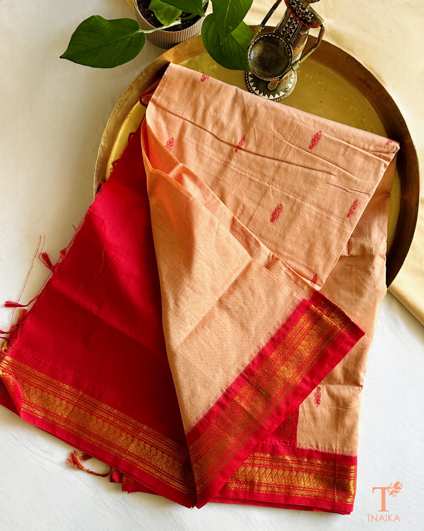 Soft cotton saree featuring traditional woven border and tassels