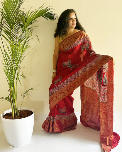 Red ethnic saree with heavy border and classic woven design