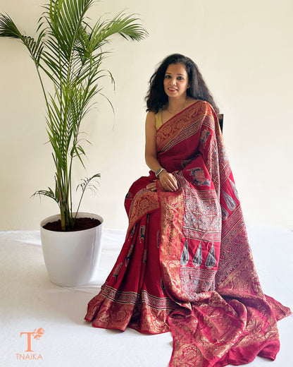 Red dola silk saree with intricate zari border and rich pallu