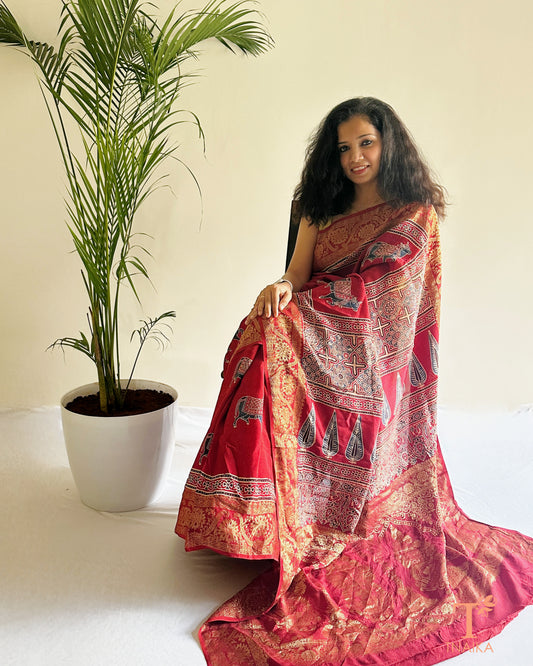 Red dola silk saree with intricate zari border and rich pallu