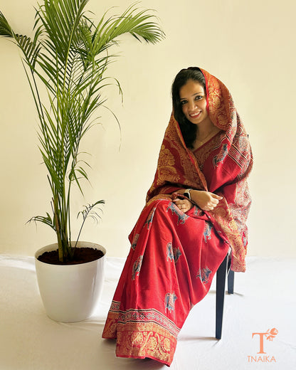 Red ethnic saree with heavy border and classic woven design