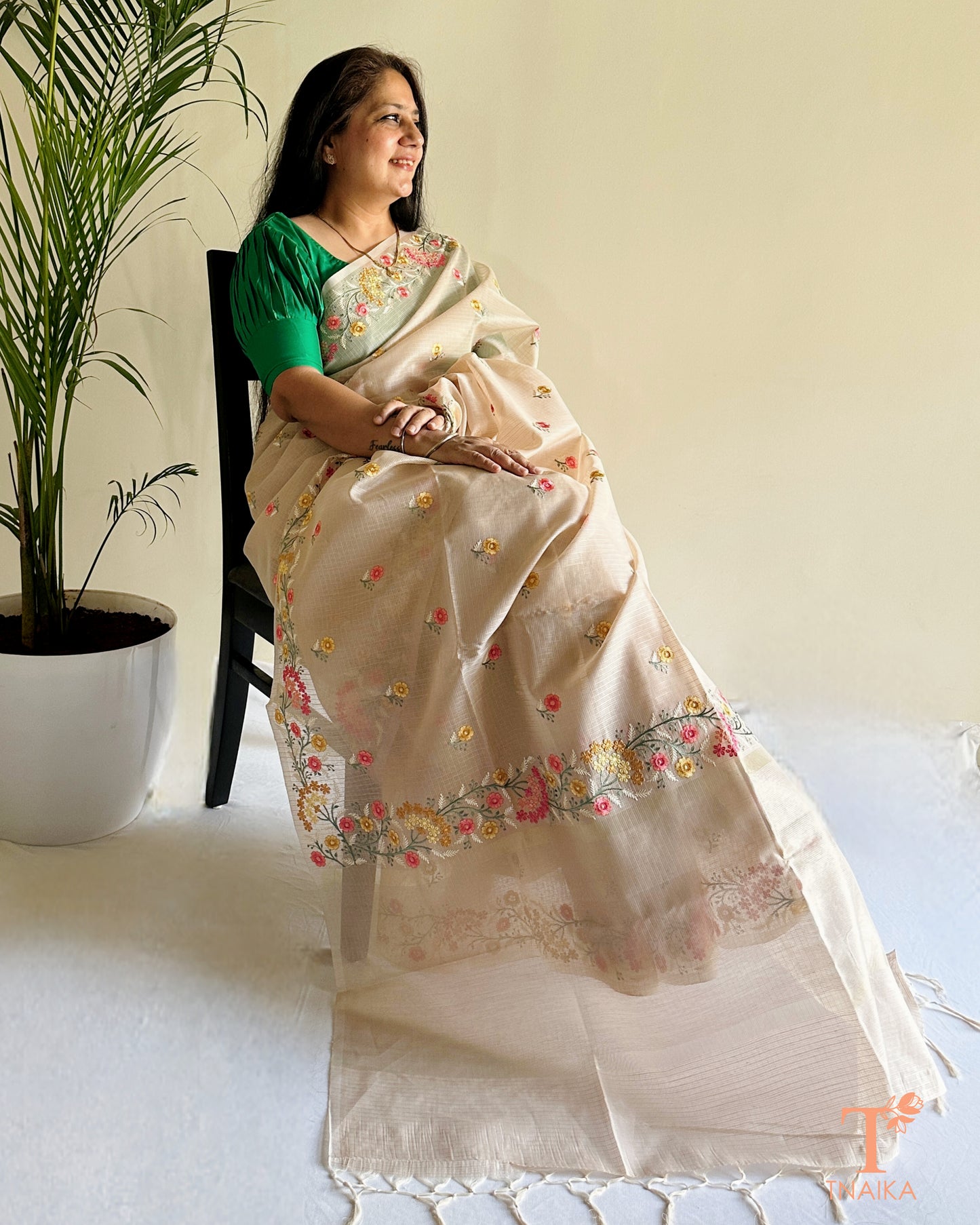 Beige kota silk saree with intricate hand-style thread embroidery and floral detailing