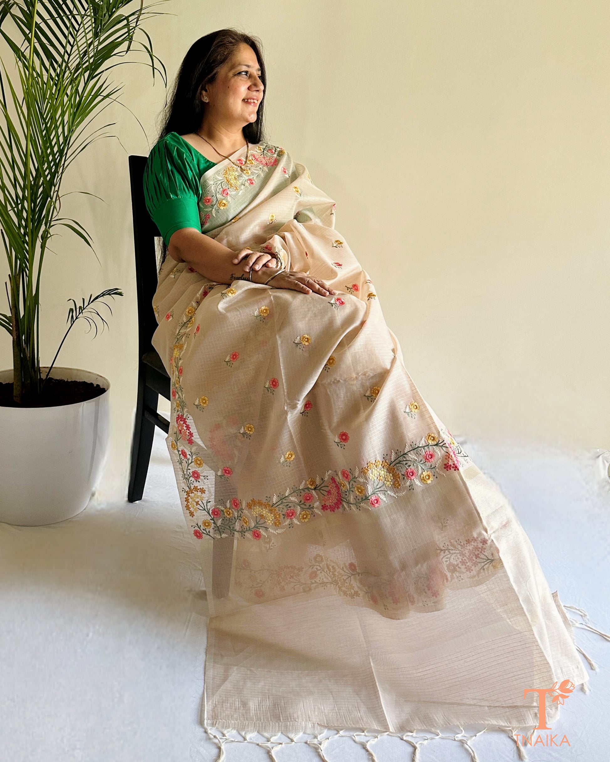 Beige kota silk saree with intricate hand-style thread embroidery and floral detailing