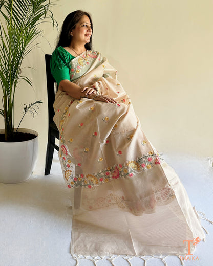 Beige kota silk saree with intricate hand-style thread embroidery and floral detailing
