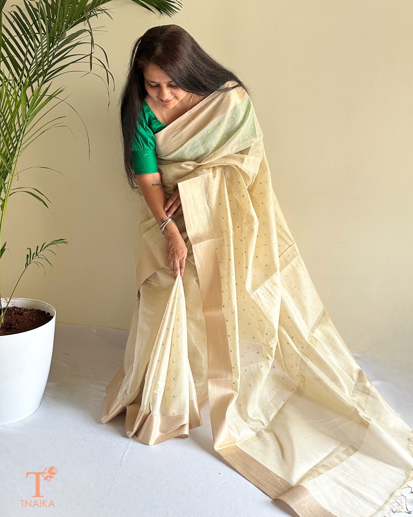 Elegant ivory saree with woven buti detailing and sheer texture