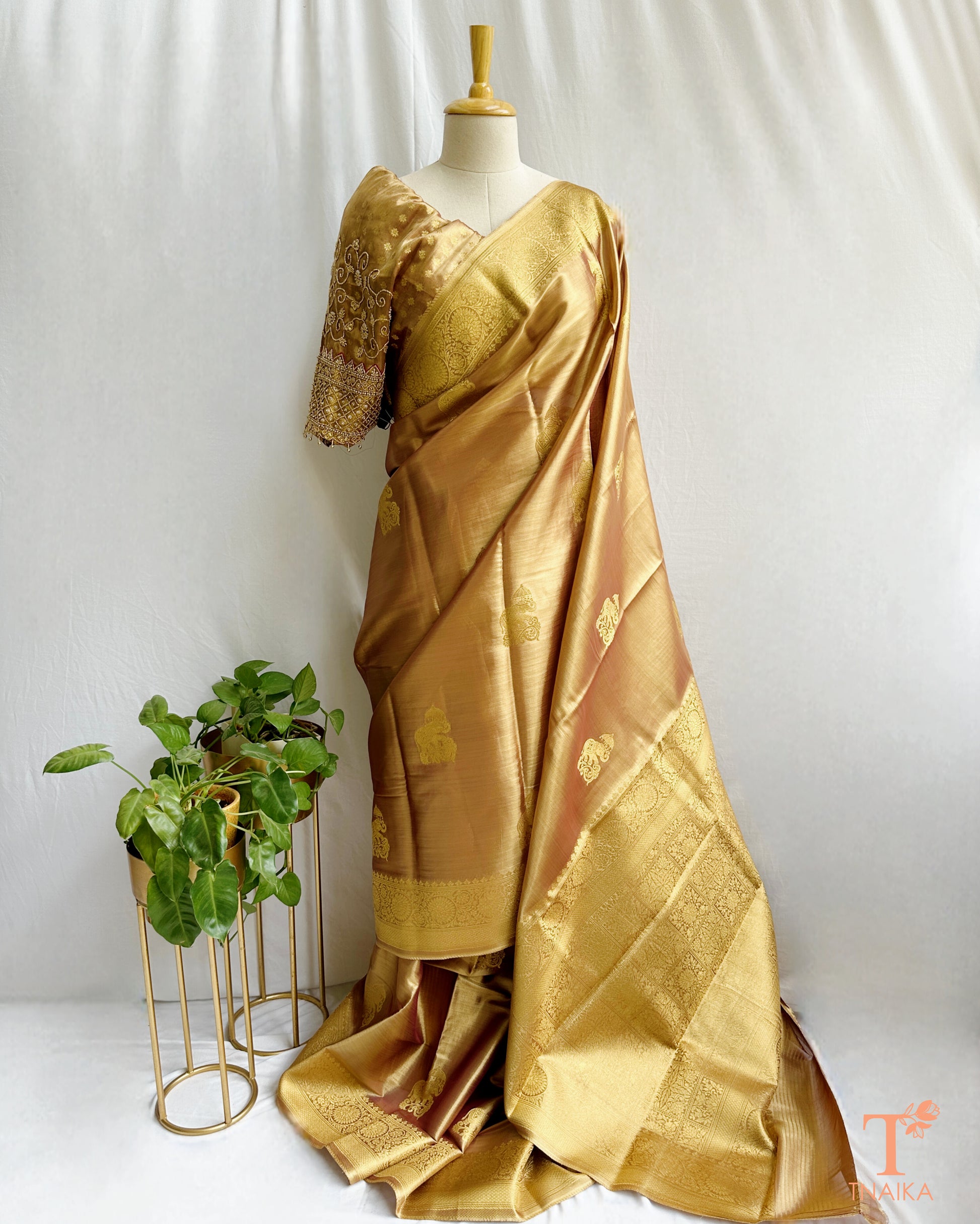 Elegant gold saree with traditional motifs and lustrous finish