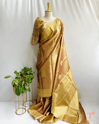 Elegant gold saree with traditional motifs and lustrous finish