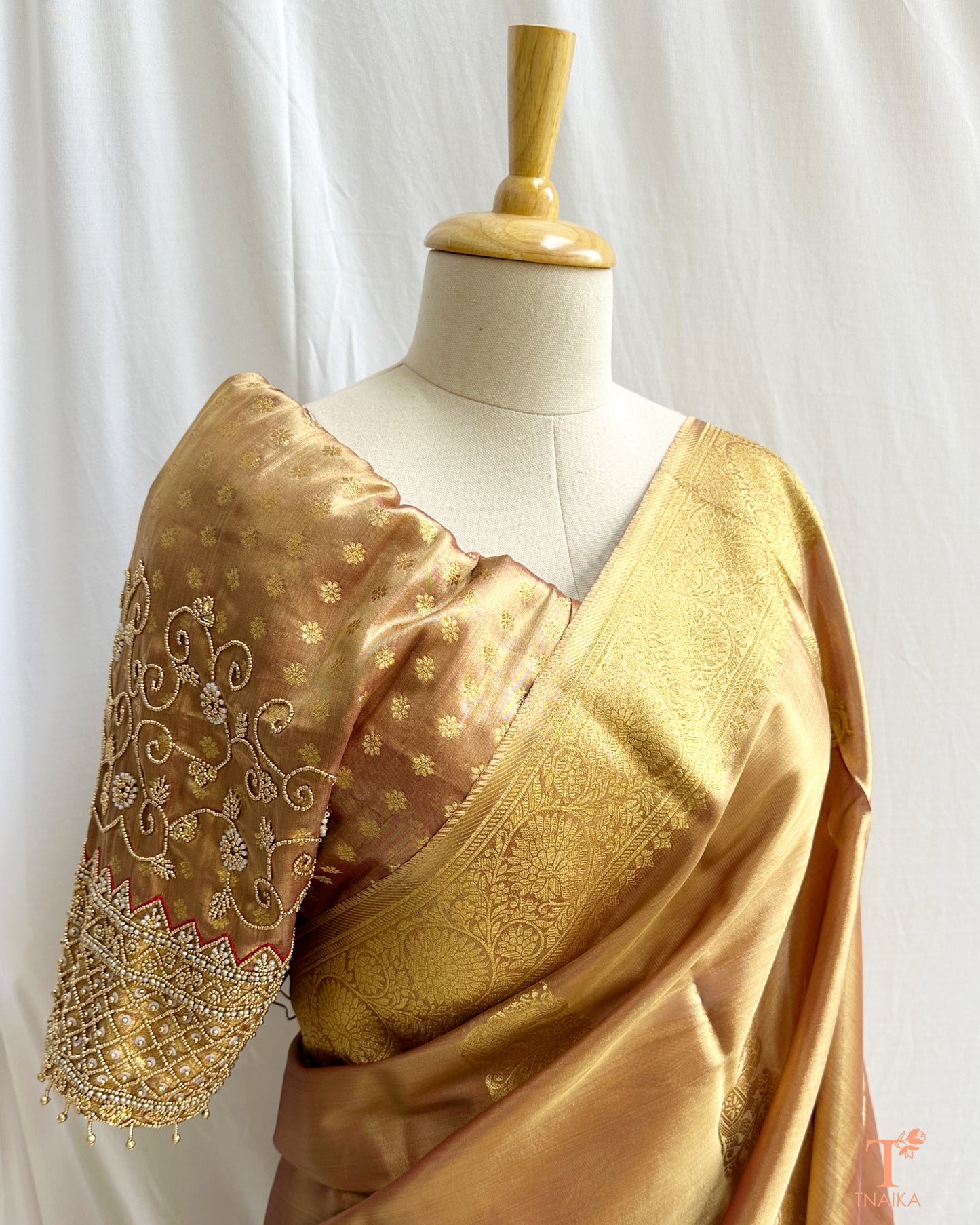 Detailed blouse sleeve with aari work and pearl embellishments