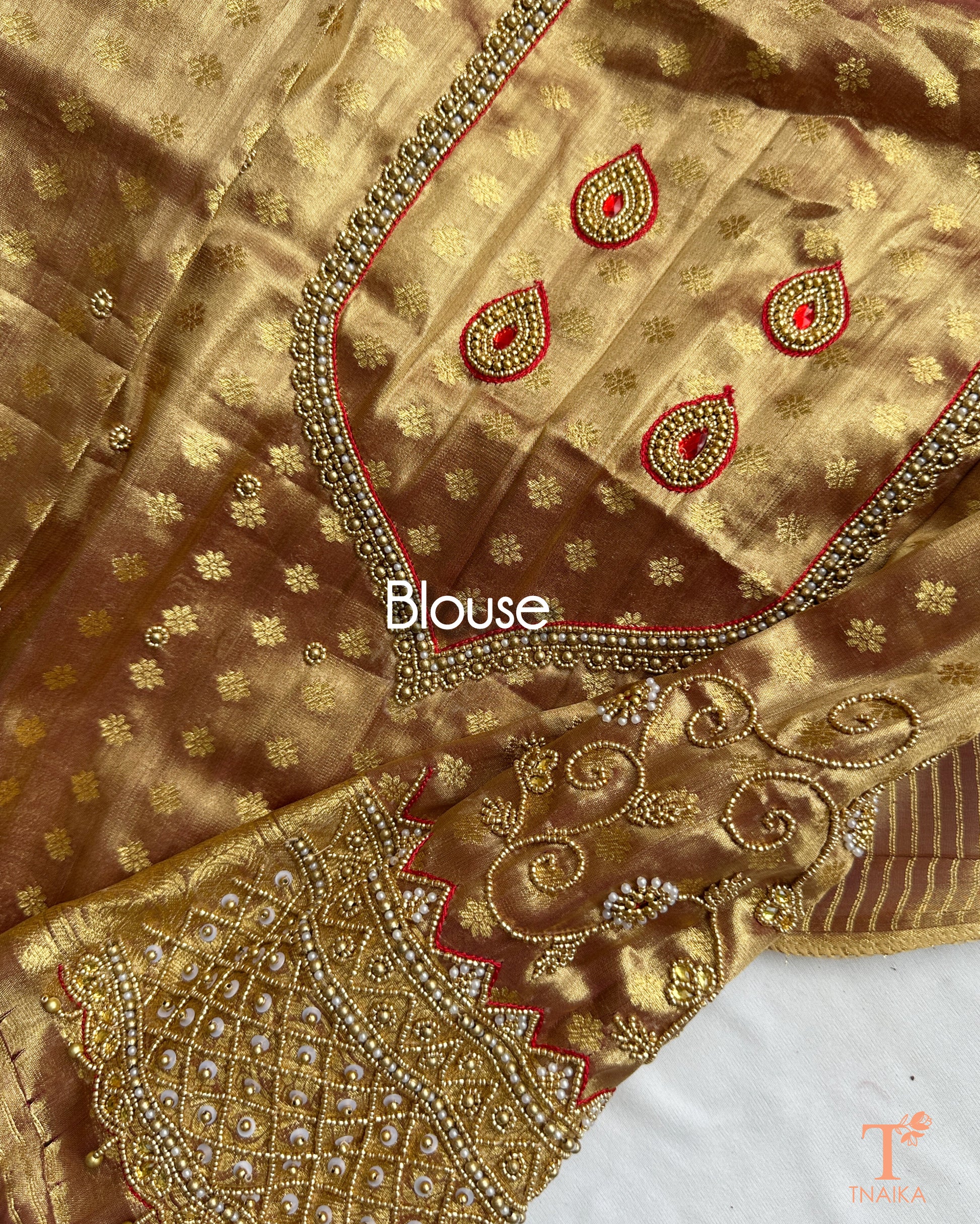 Detailed blouse sleeve with aari work and pearl embellishments