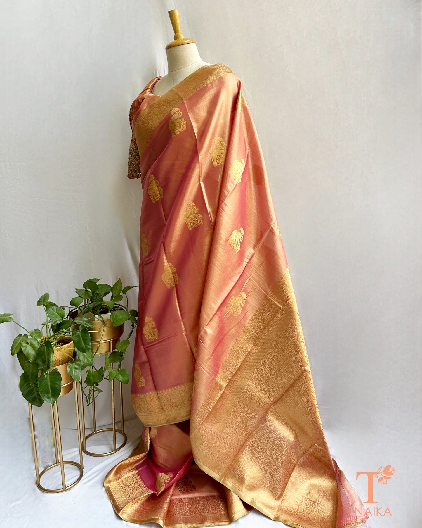 Elegant gold saree with traditional motifs and lustrous finish