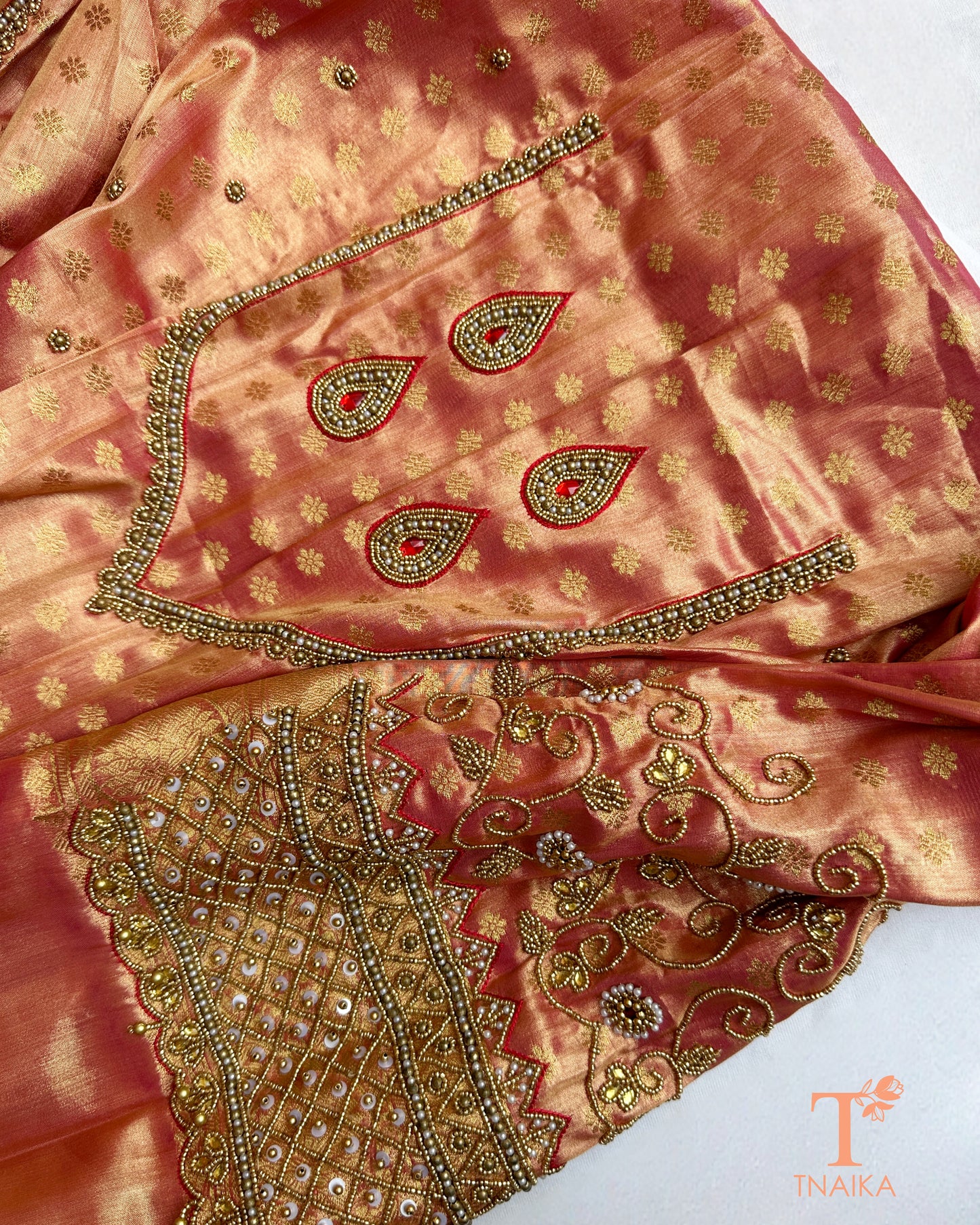 Detailed blouse sleeve with aari work and pearl embellishments