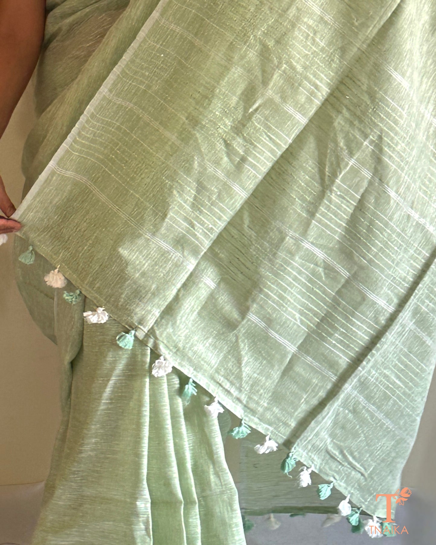 elegant linen saree with classic zari pallu and tassels