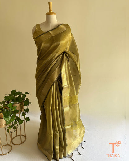 Close-up of olive green tissue silk saree featuring fine checks weave, zari border, and striped pallu detailing